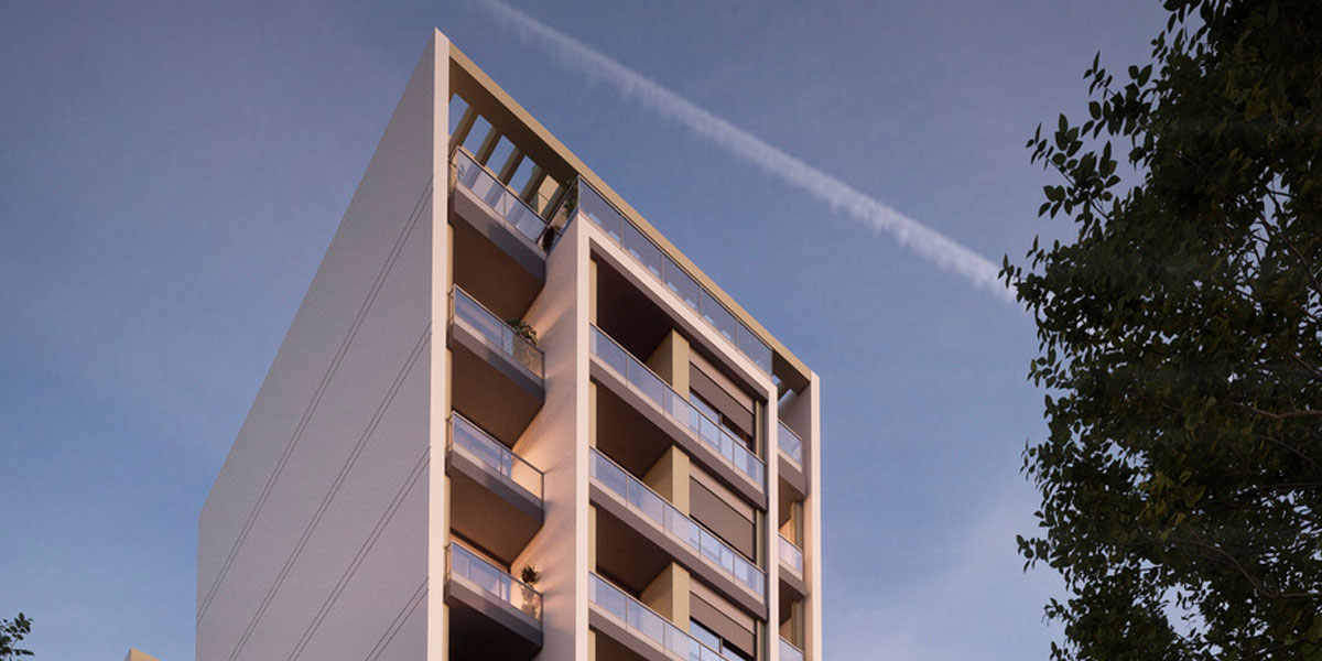 Fachada de Horus Art III al atardecer, esquina con balcones iluminados